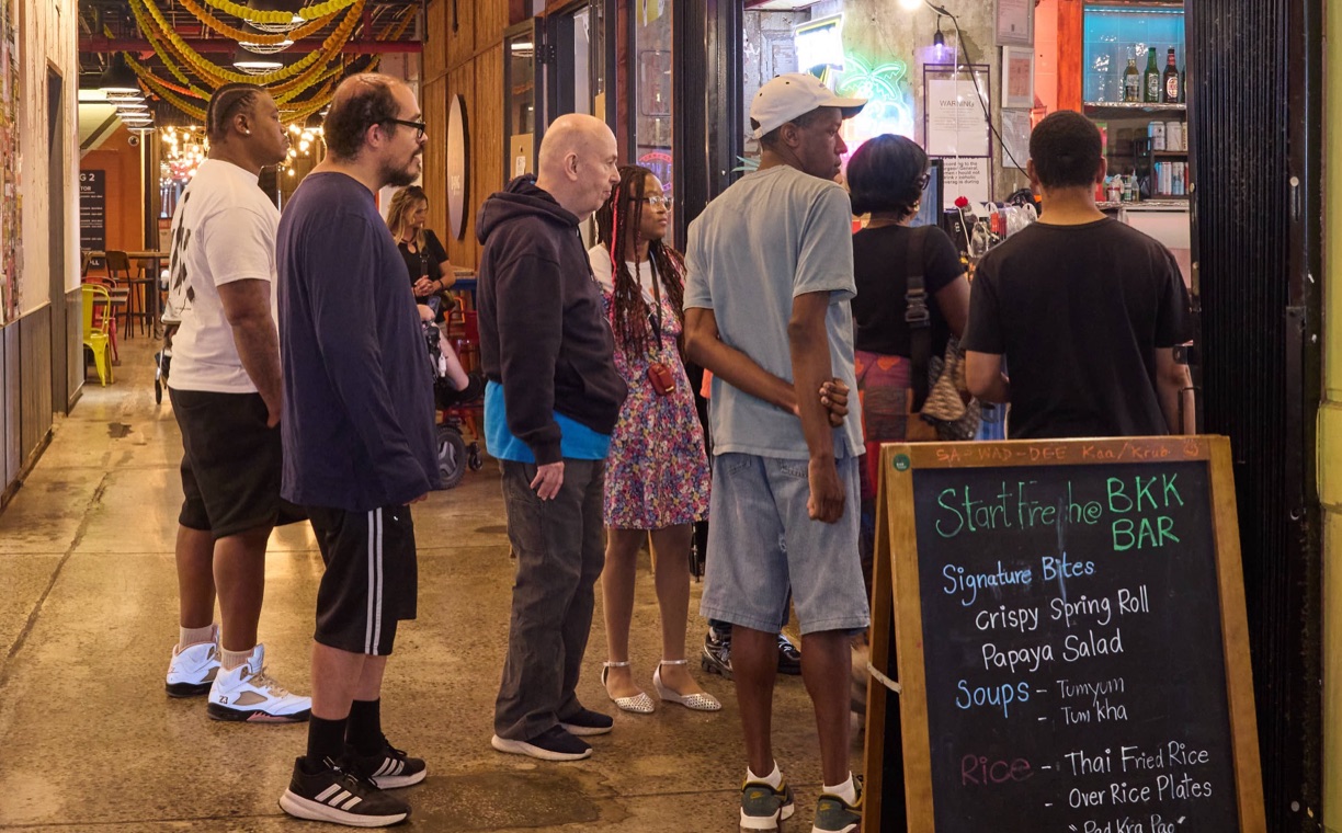 People browsing local shops during a community outing