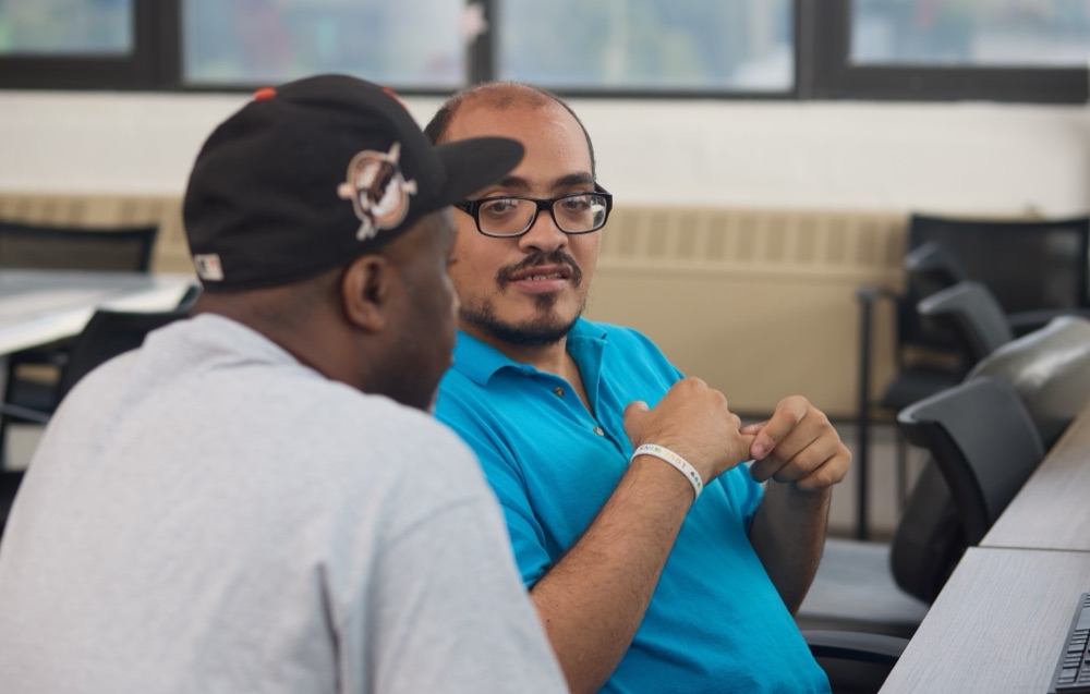 Two program participants talking during a day program session